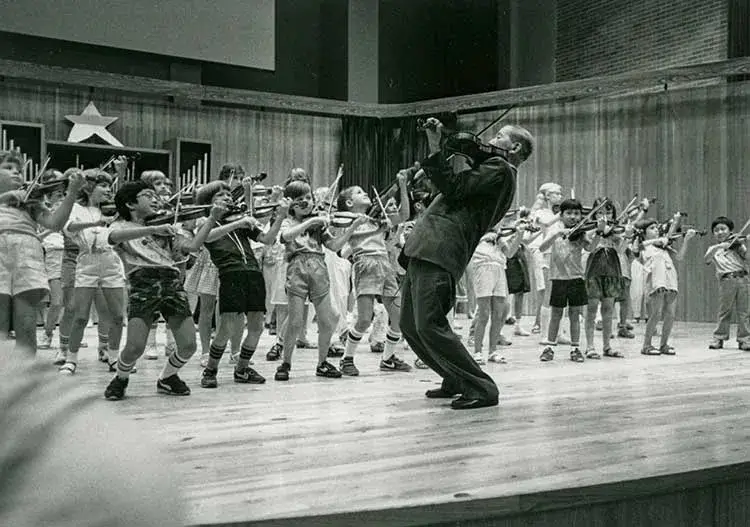 Dr. Shinichi Suzuki teaching young violinists